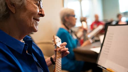 Older adult learning how to play an instrument